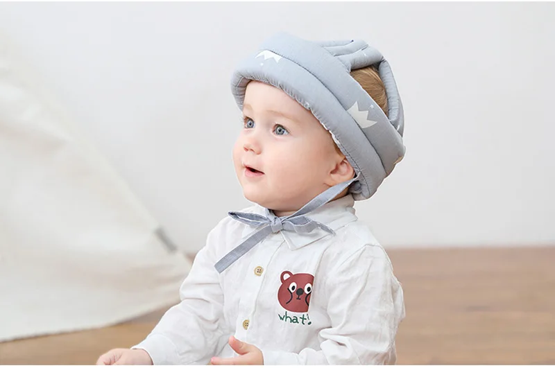 A cheerful baby wearing the SafeTots helmet while exploring a playroom, highlighting the helmet's comfortable fit and protective design.